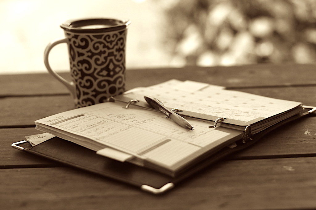 Planner, pen, and coffee mug.