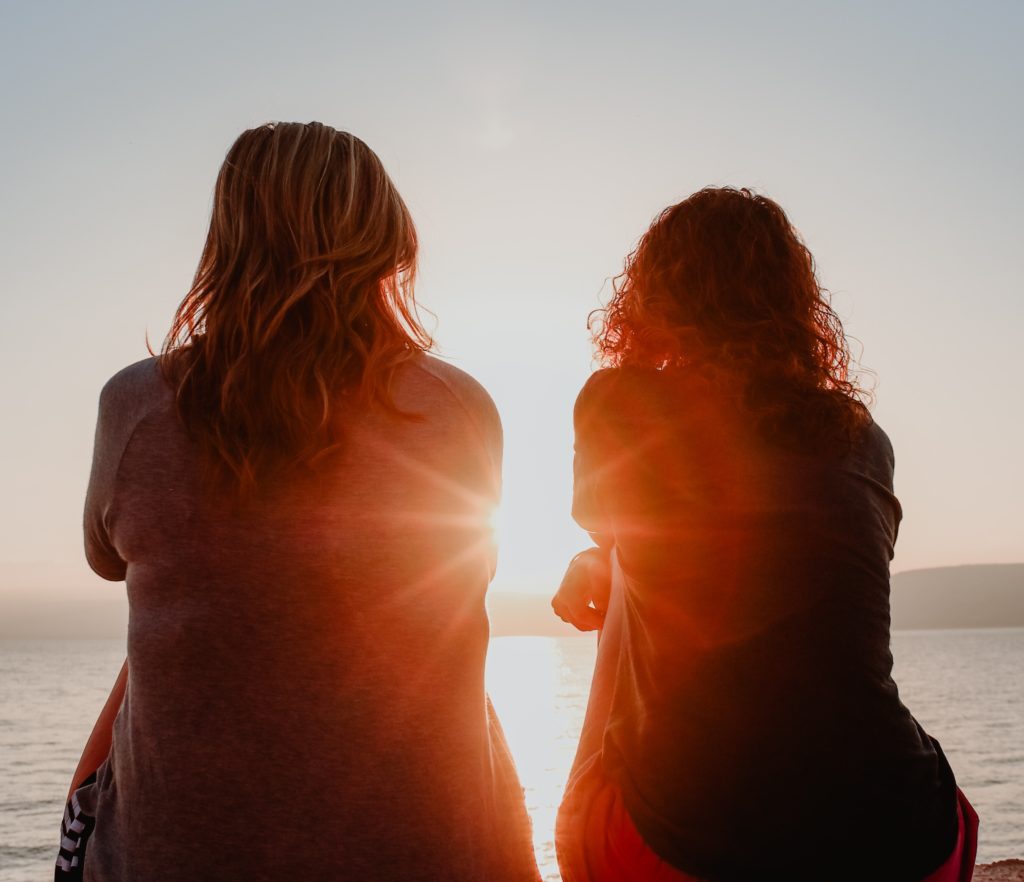 Women talking, mentoring - in the sunset